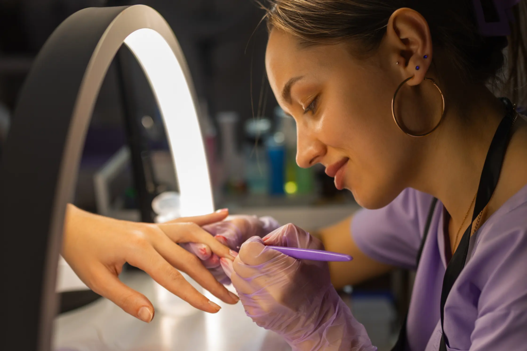 woman-performing-a-manicure-with-purple-tools-2026-03-27-02-25-42-utc