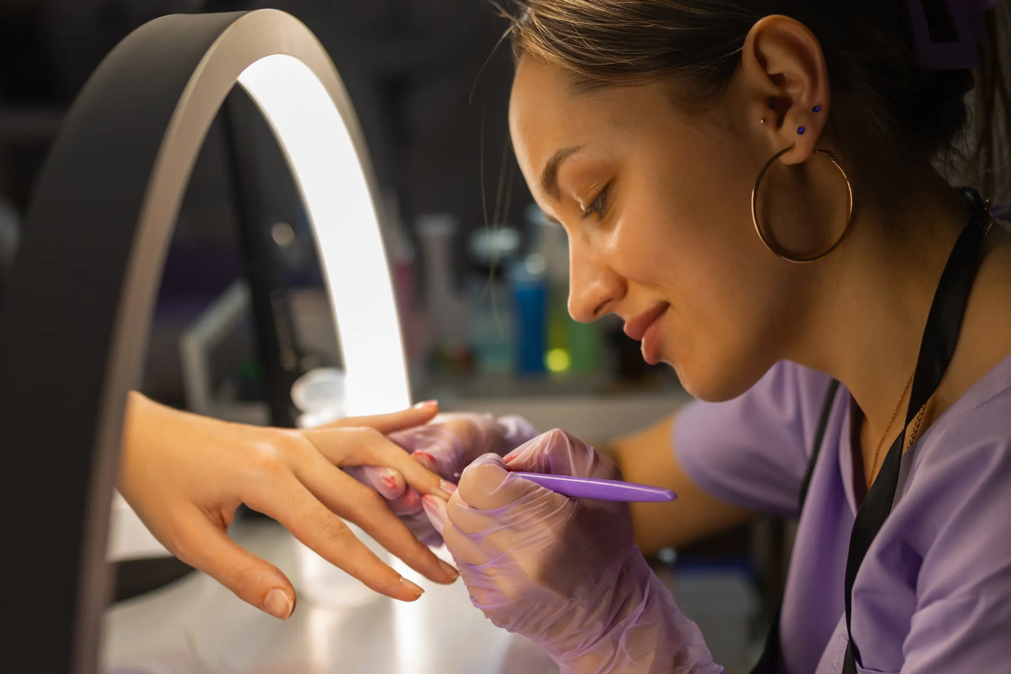 woman-performing-a-manicure-with-purple-tools-2026-03-27-02-25-42-utc